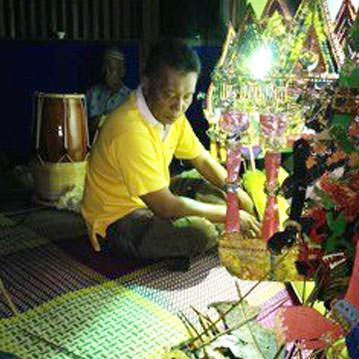 Person in yellow shirt sits near bright light