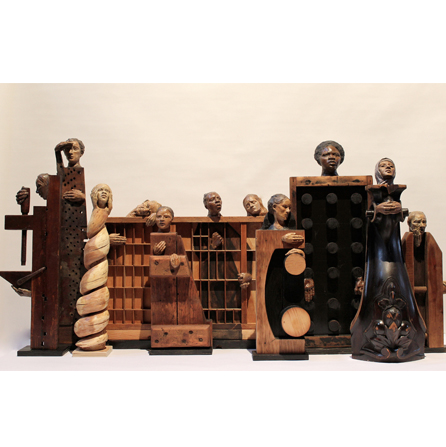 Wooden scuplute of various heads with non-human body forms