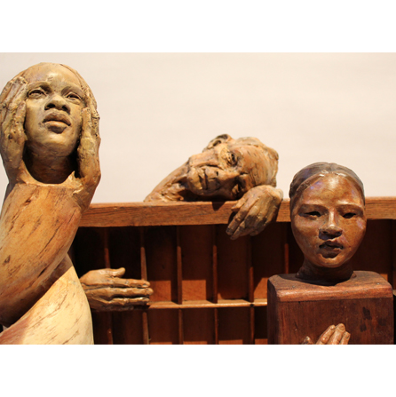 Wooden sculture of 3 heads and hands in various poses