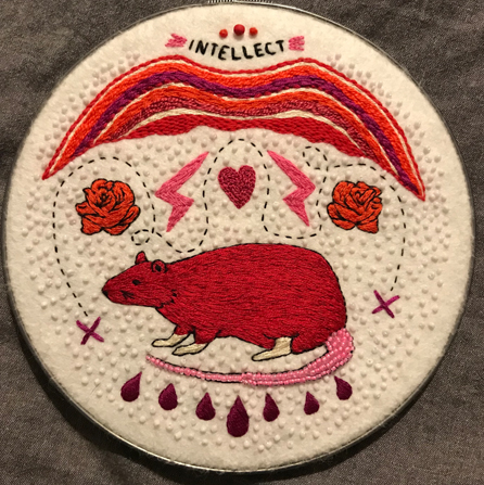 Embroidery in tones of red featuring the word "INTELLECT" and a large rat