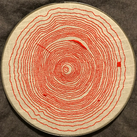 Red embroidery resembling tree rings