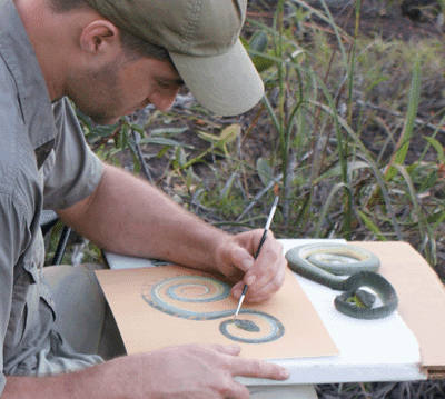 James Prosek painting a watercolor of a snake in the field from life