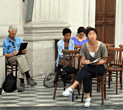 4 people sit sketching