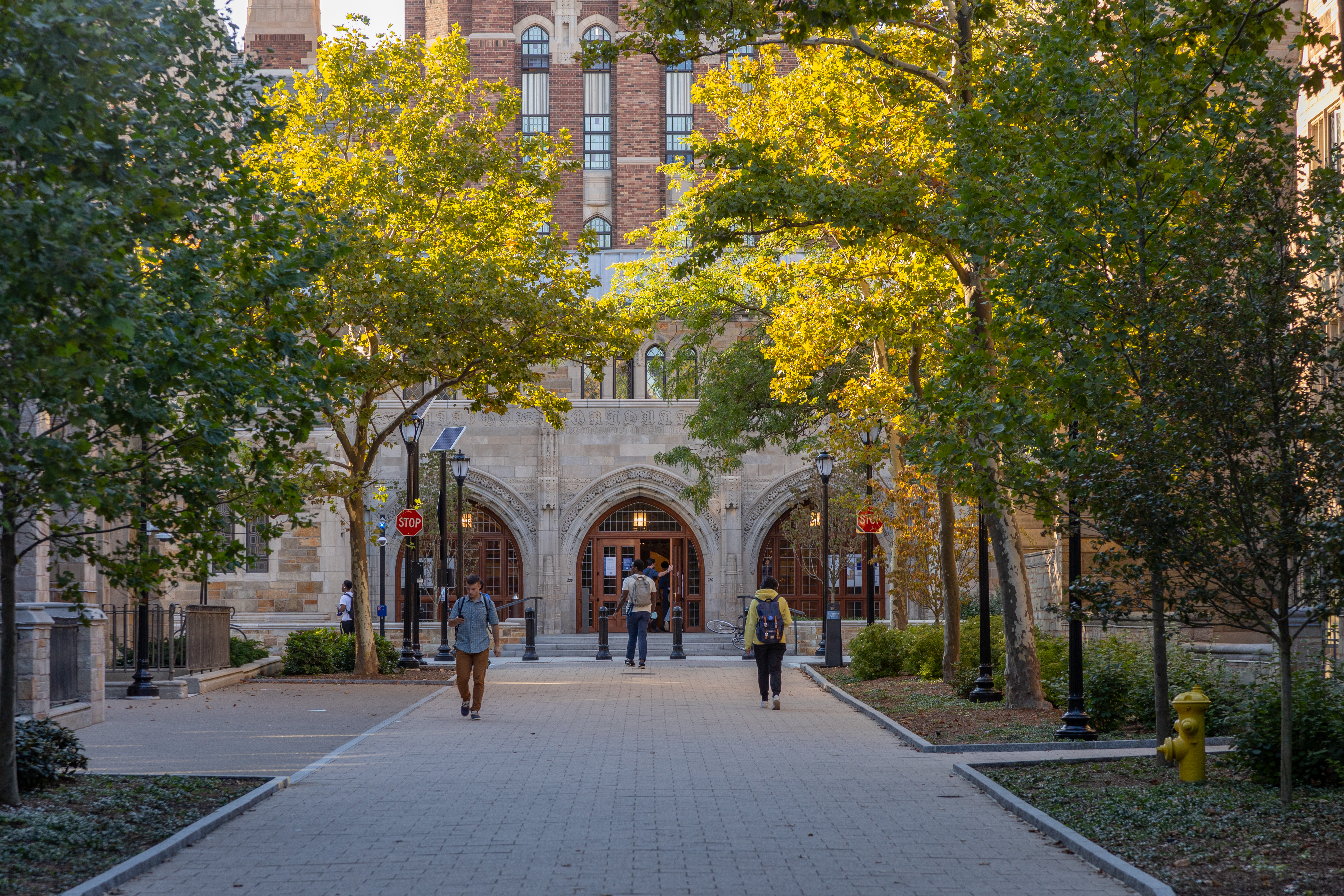 People walking near front entrance of the Humanities Quadrangle